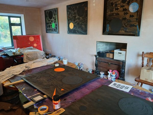Applying acrylic paint layer to textured plaster canvas