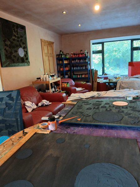 Artist working in studio with set square and drafting tools